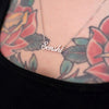 Silver necklace that says "Senshi" on tattooed model