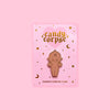 Chocolate kewpie enamel pin on pink and gold foil backing cards
