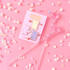 Gummi bear enamel pins on a pink background with candy sprinkles on the background