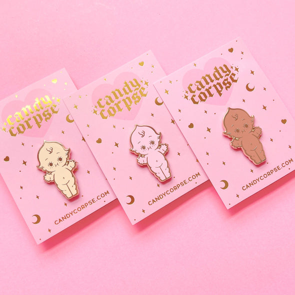 Ice cream kewpie pins in vanilla, strawberry, and chocolate on a pink background