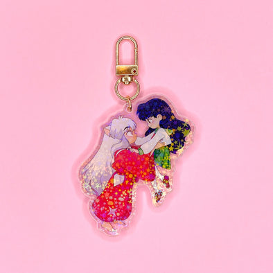 Acrylic keychain with star holographic finish and gold key ring. Artwork shows a dog boy and schoolgirl as an adorable couple.
